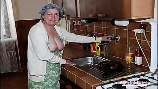 Sultry older woman teases with a silk sheet, revealing her voluptuous body before engaging in a steamy lesbian encounter.
